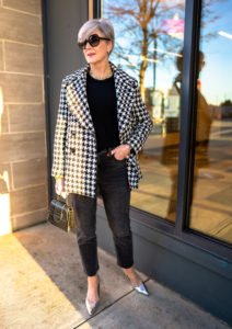 a houndstooth blazer and black denim jeans