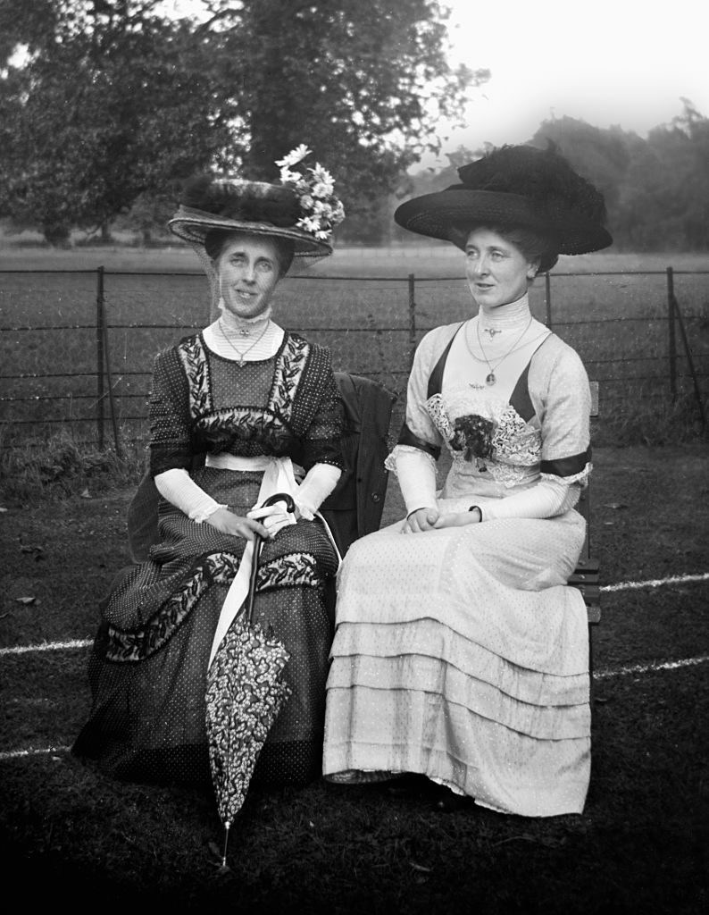 Two Victorian women sit on a park bench in England, ca. 1900 (Photo by Kirn Vintage Stock/Corbis via Getty Images)