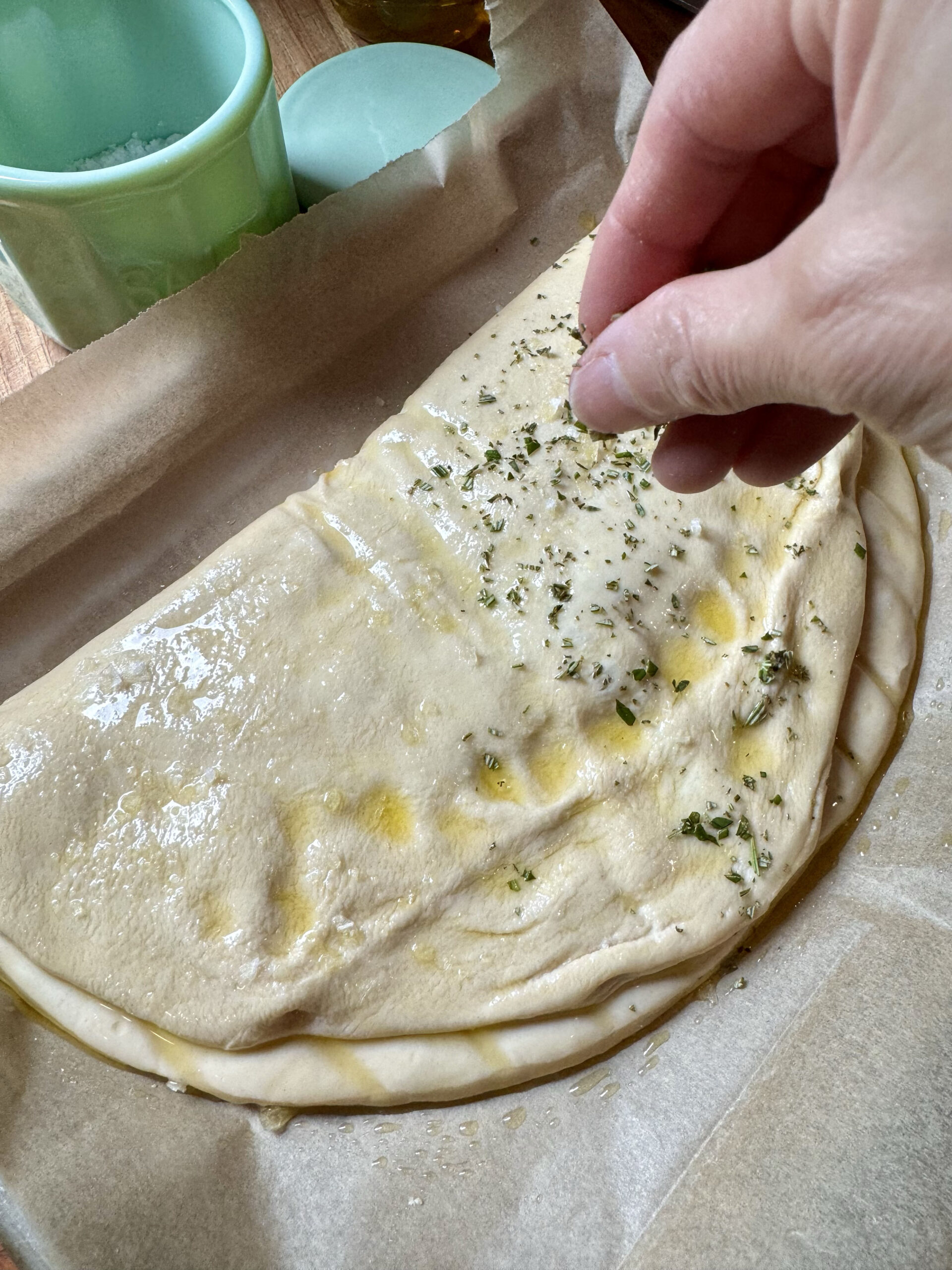 Sprinkle the top with flaky sea salt and minced fresh rosemary and thyme